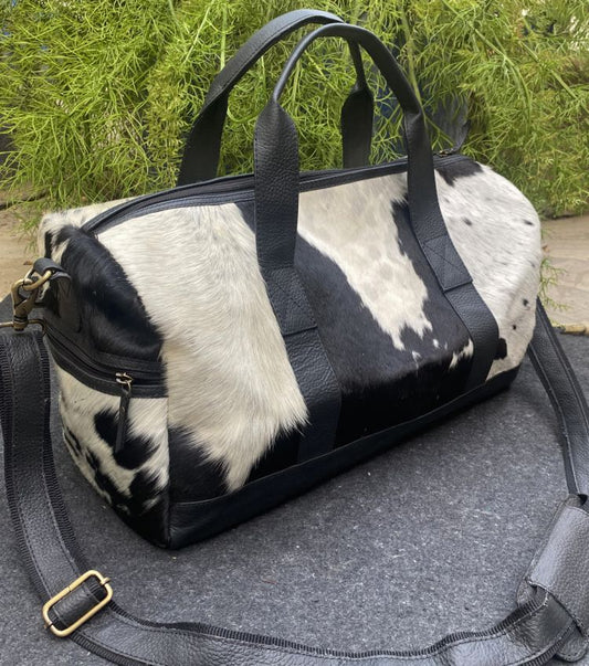 Black and white cowhide duffle bag