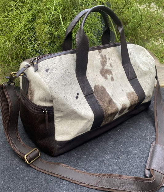 Hair on cowhide white and brown duffle bag